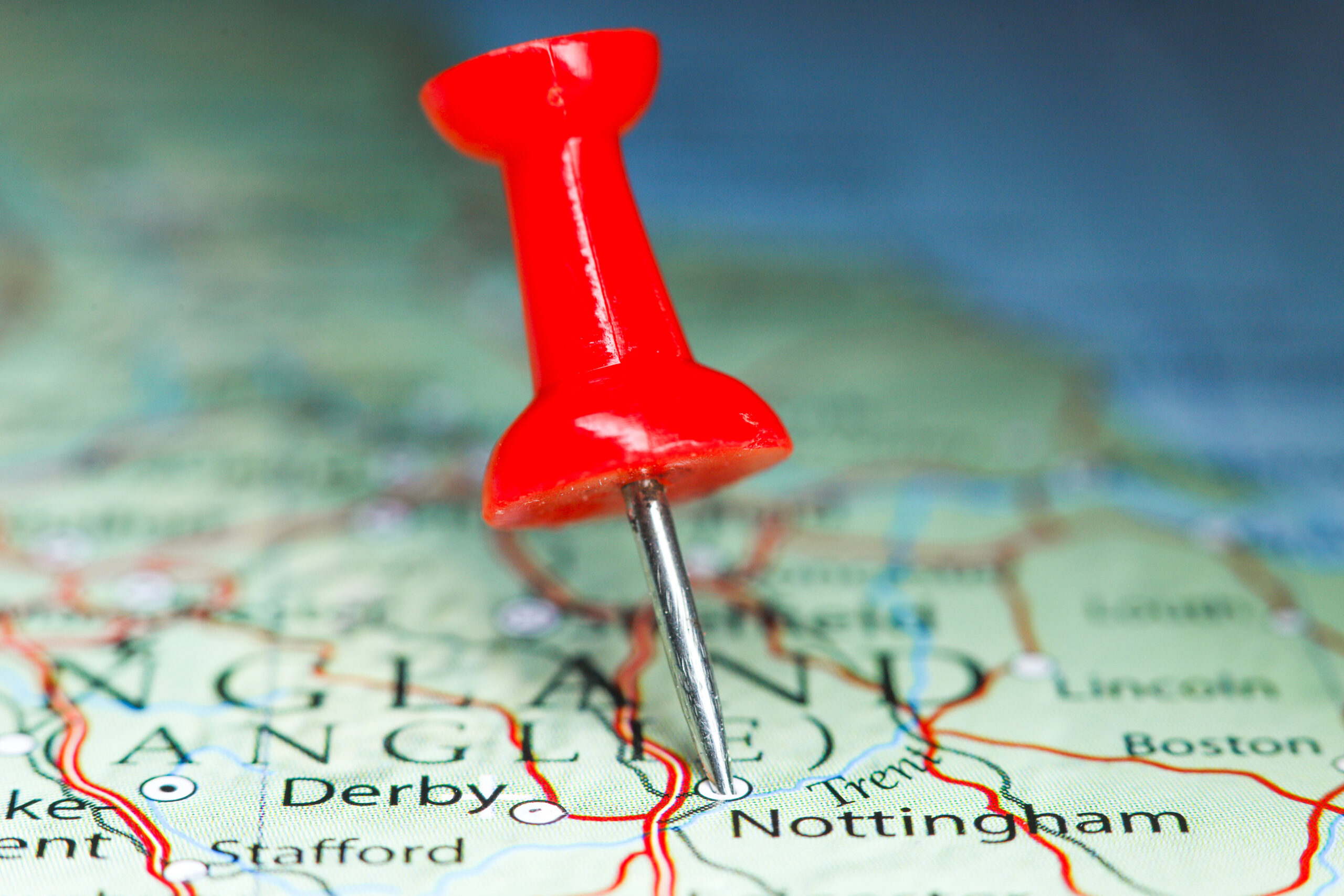 Pinpointed location of a city, country on a map. Red pushpin highlighting a location.